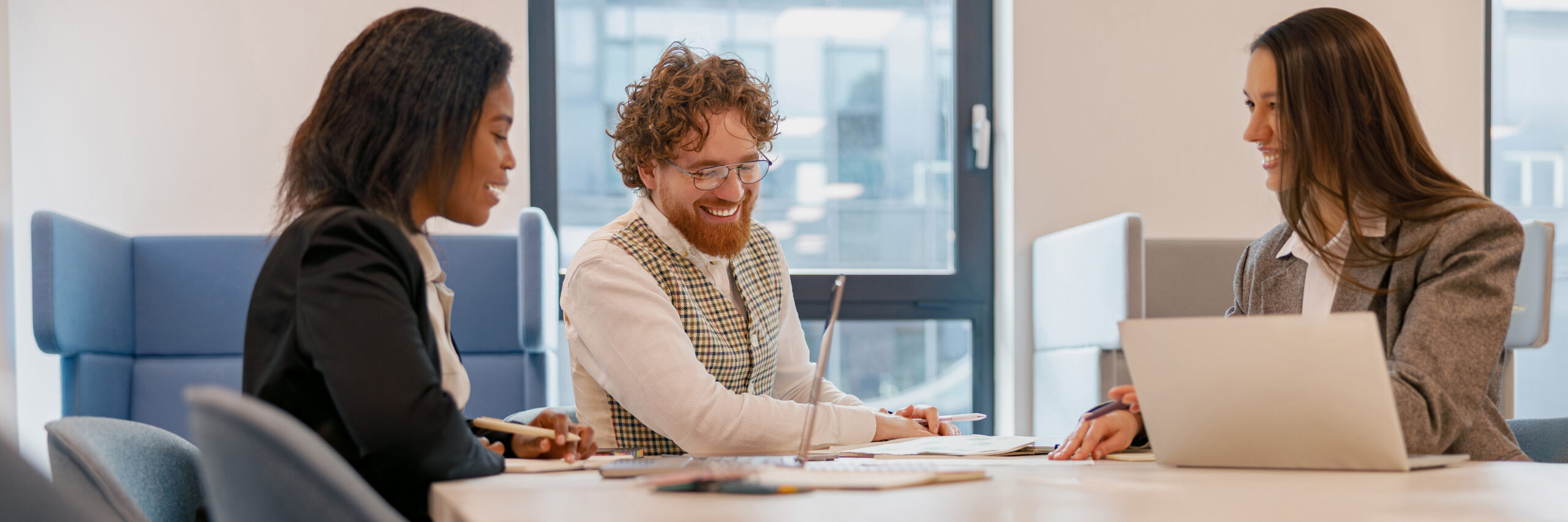 In a modern office, a diverse and skilled team collaborates effectively in an important business meeting